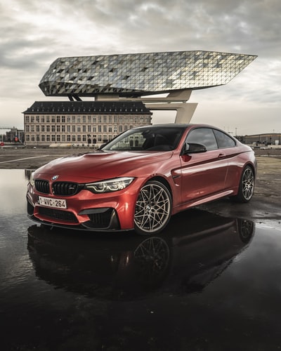 Roads during the day the red BMW m 3 cars
